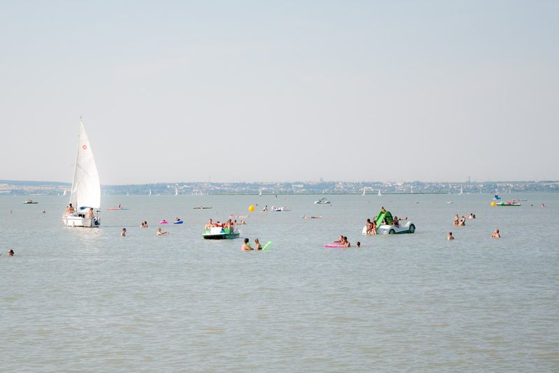 Segelboot und Badende am Neusiedler See